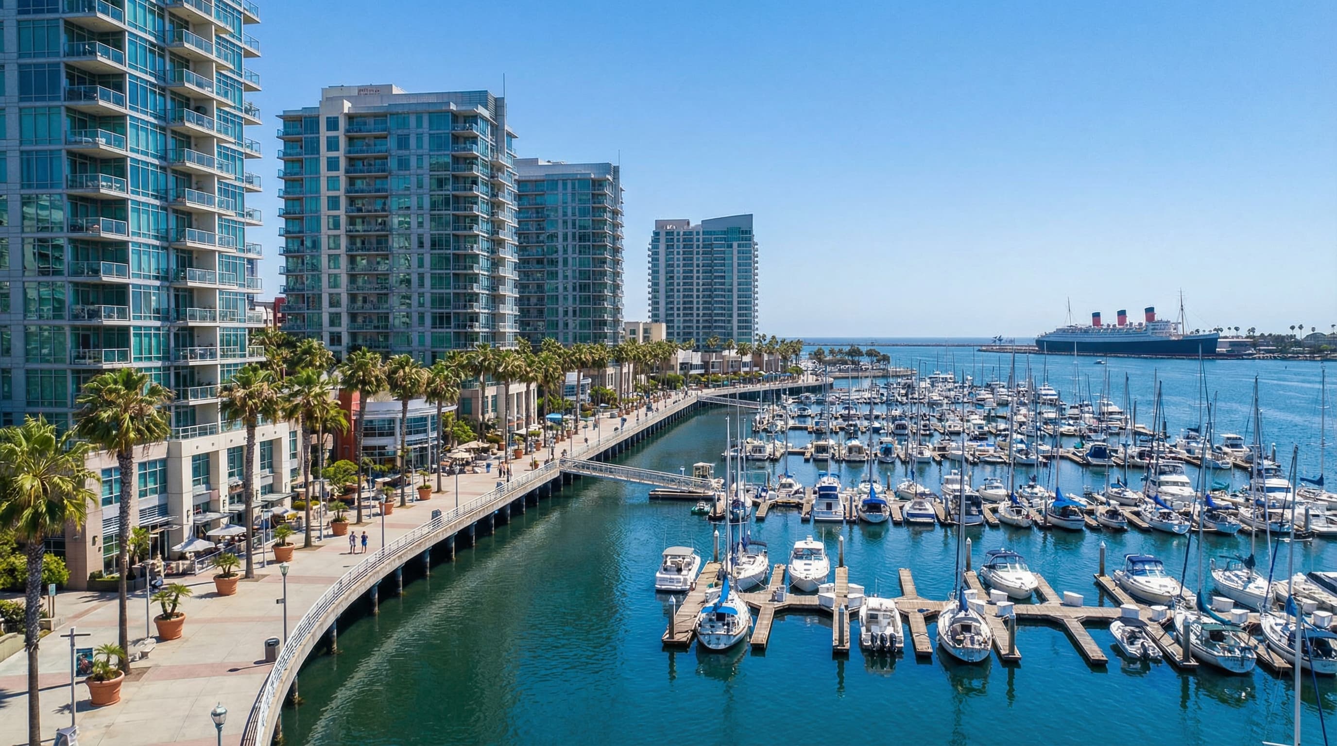 Long Beach California downtown waterfront and marina with modern high-rise condominiums and Queen Mary in distance