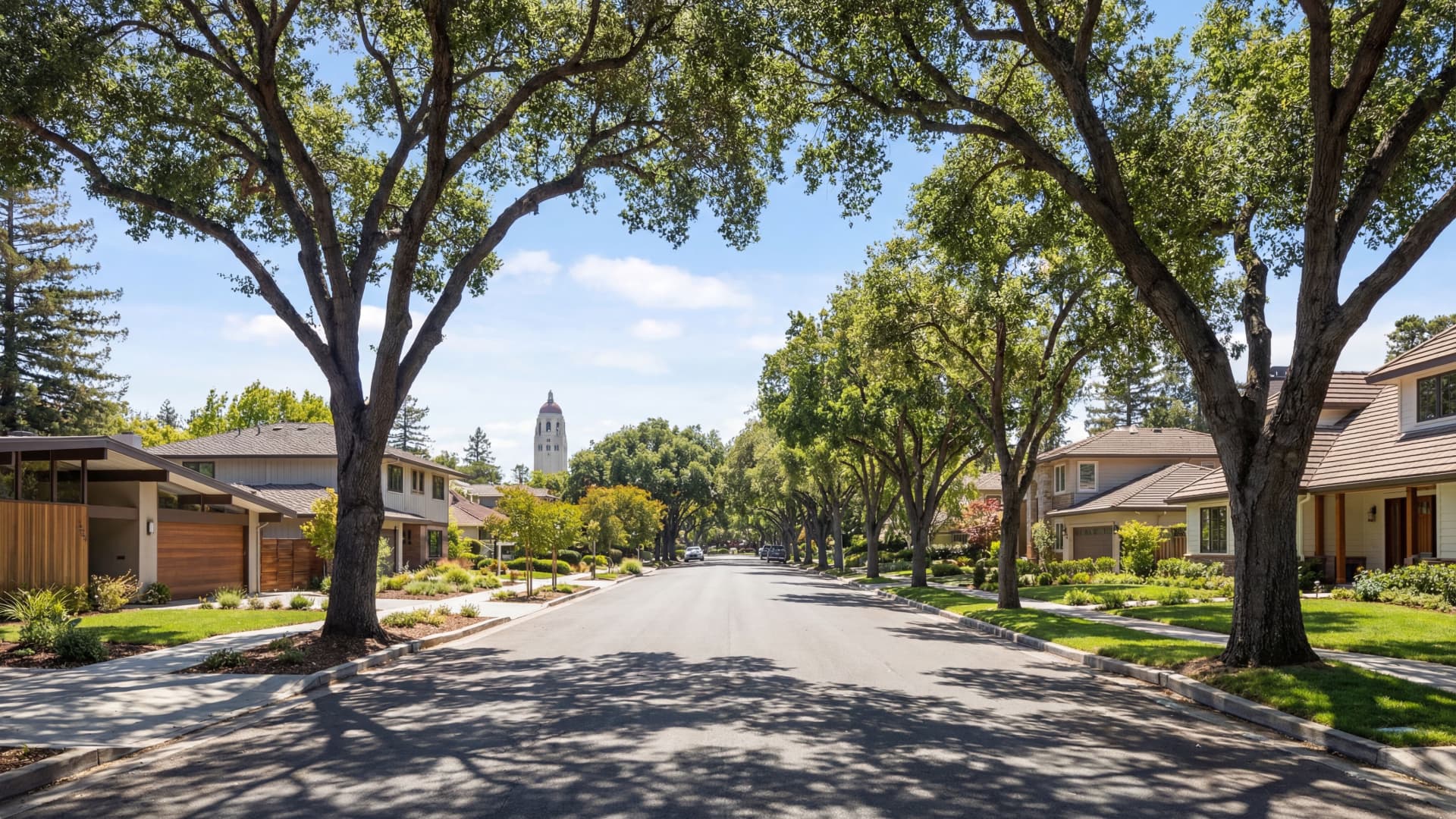 Prestigious Palo Alto tree-lined street with California homes and Stanford Hoover Tower